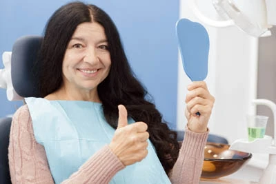 woman loving her smile after services from CareSmiles Dental