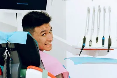 man smiling after getting root canal therapy at CareSmiles Dental