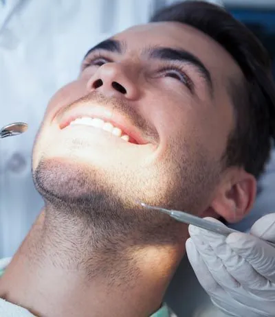 man getting his teeth cleaned at CareSmiles Dental