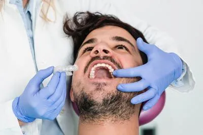 man being fitted for aligners at CareSmiles Dental